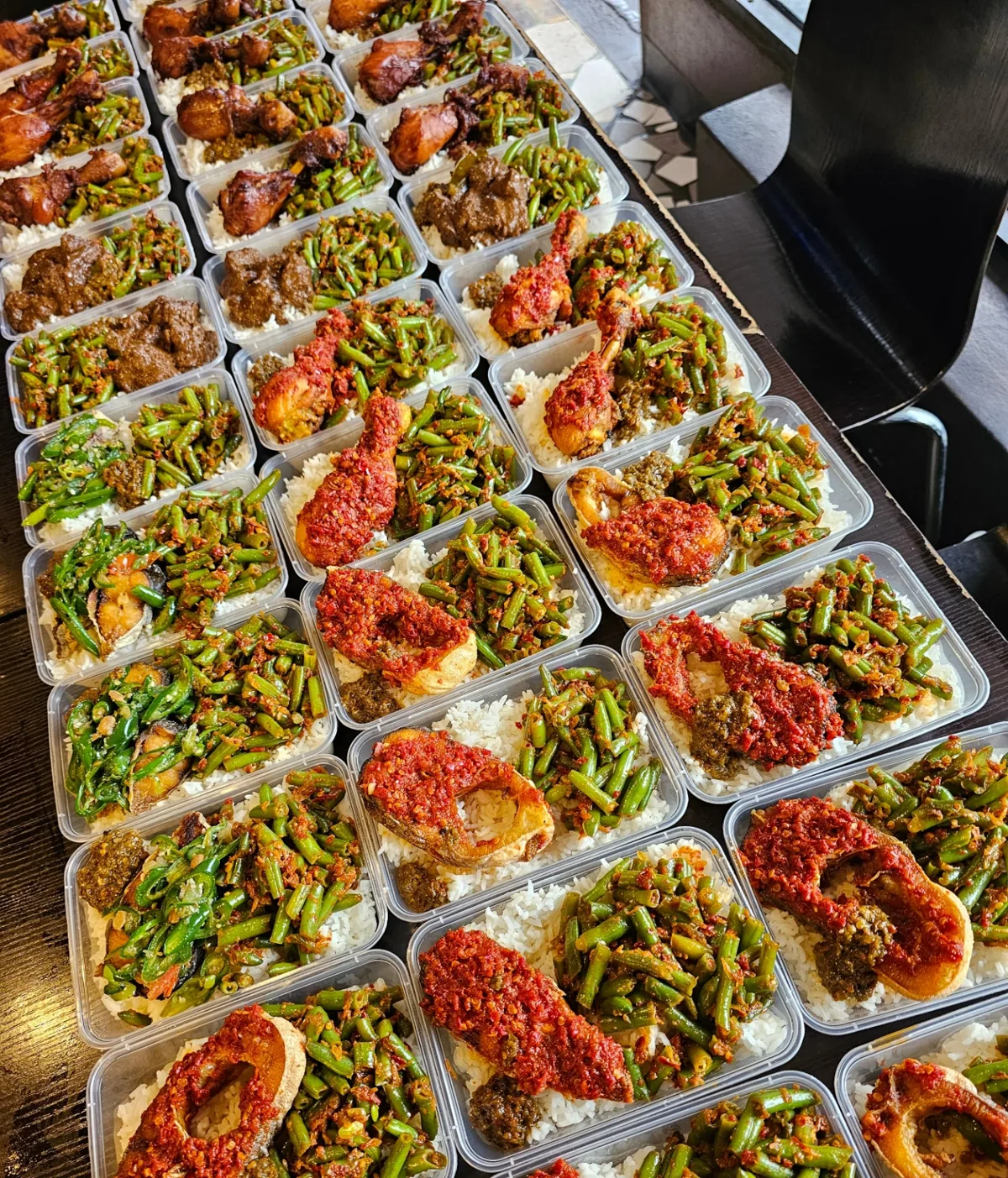 Individual lunch boxes with rice, vegetables and side dishes