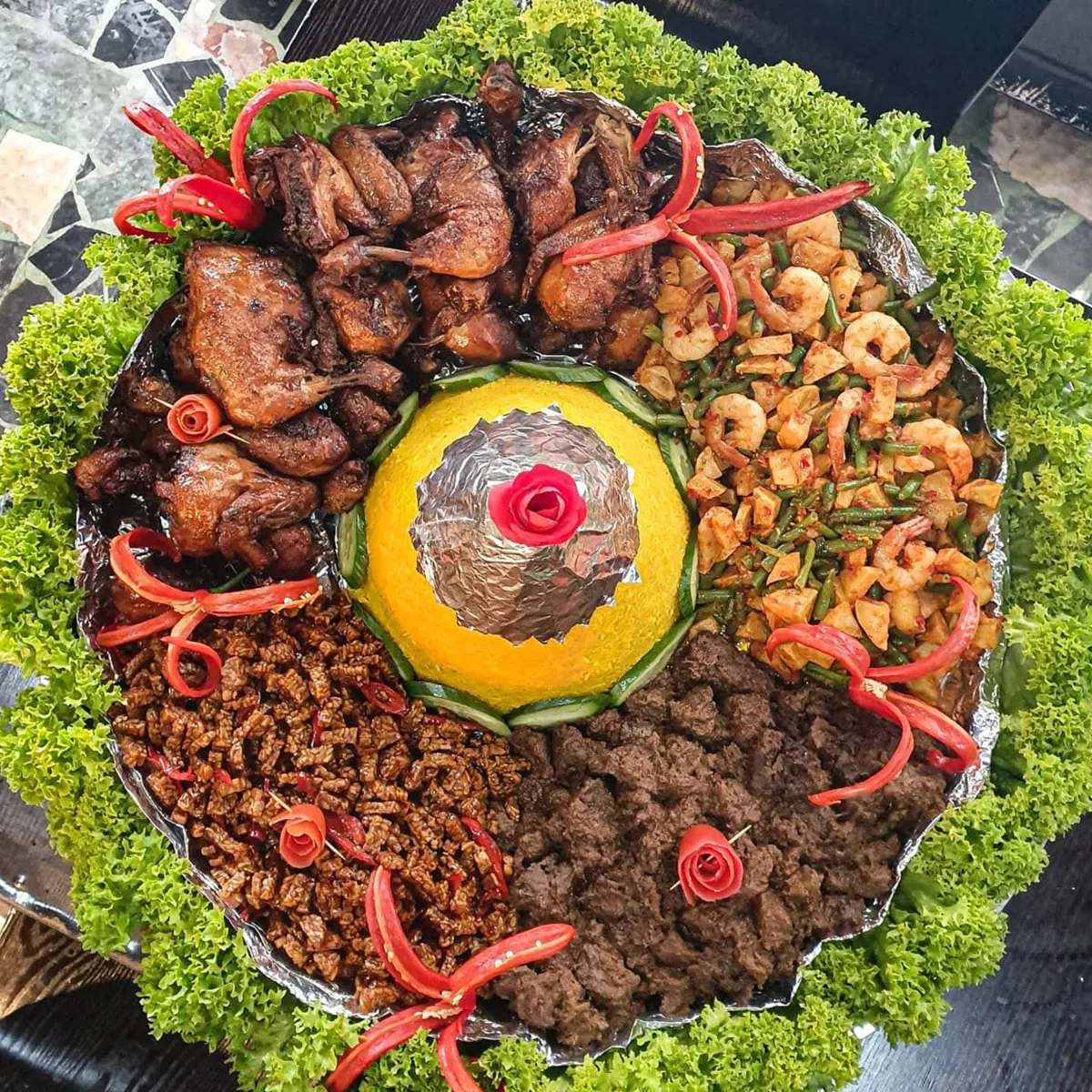A celebration platter of rice and Indonesian accompaniments